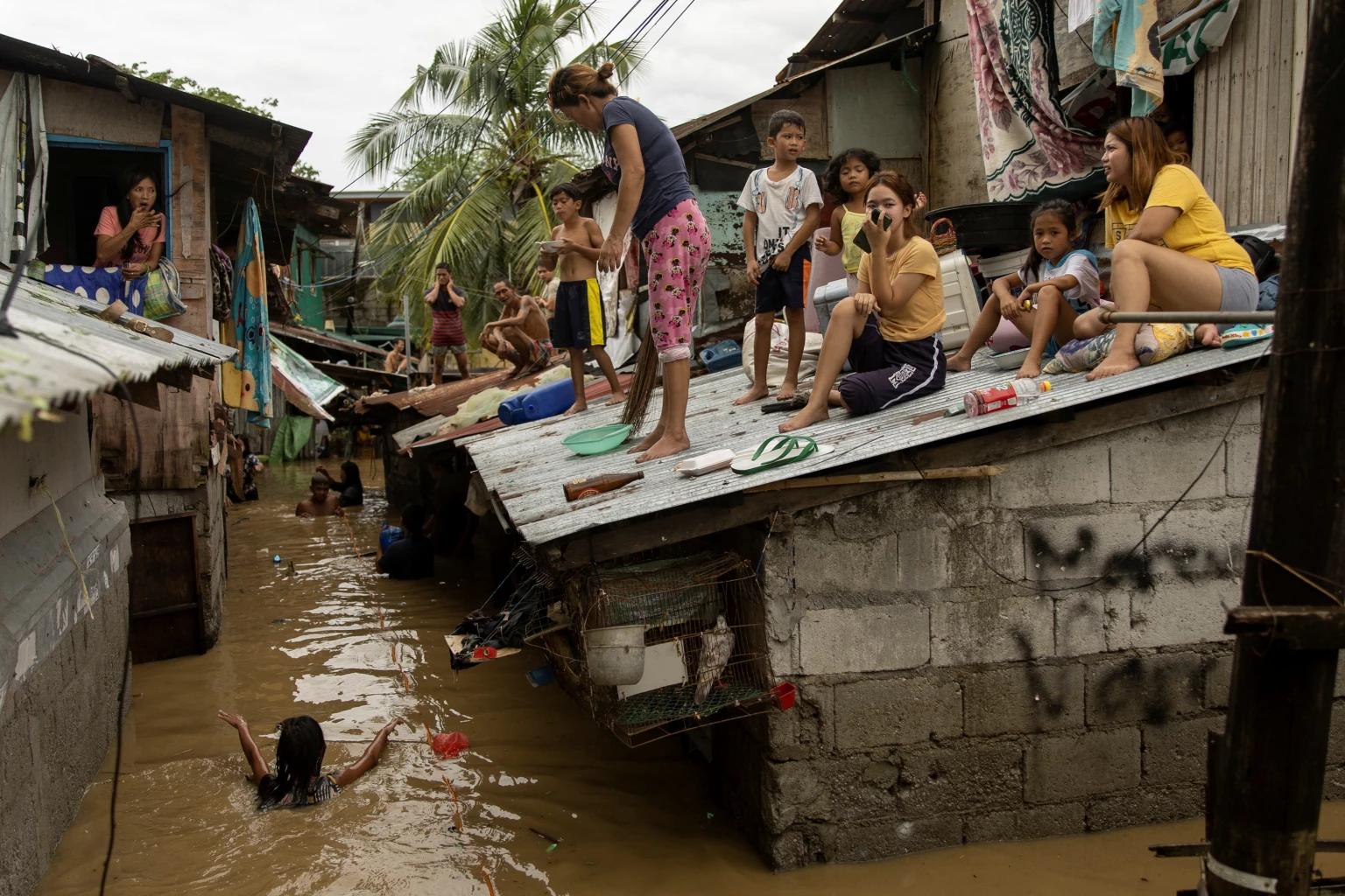 Heavy rains from Typhoon Noru flood houses in northern Philippines